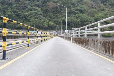 Empty road leading towards mountain