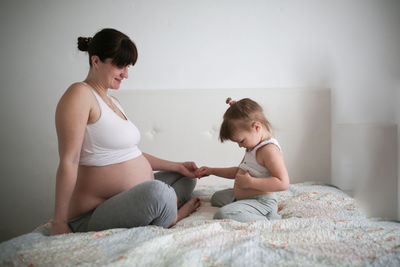 Pregnant mother with daughters, life style in a real interior. the concept of large families 