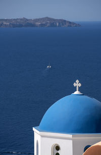 High angle view of dome church against sea at santorini during sunny day