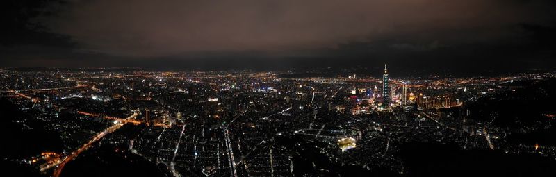 High angle view of illuminated city against sky at night