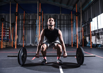 Full length of man exercising at gym