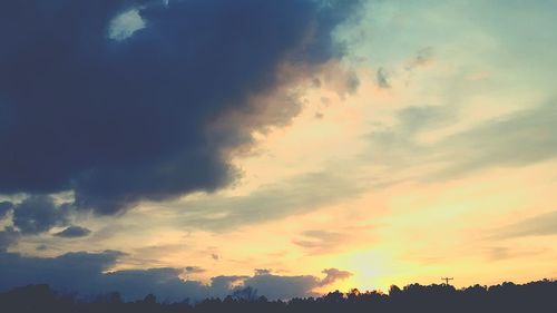 Low angle view of silhouette trees against sky during sunset