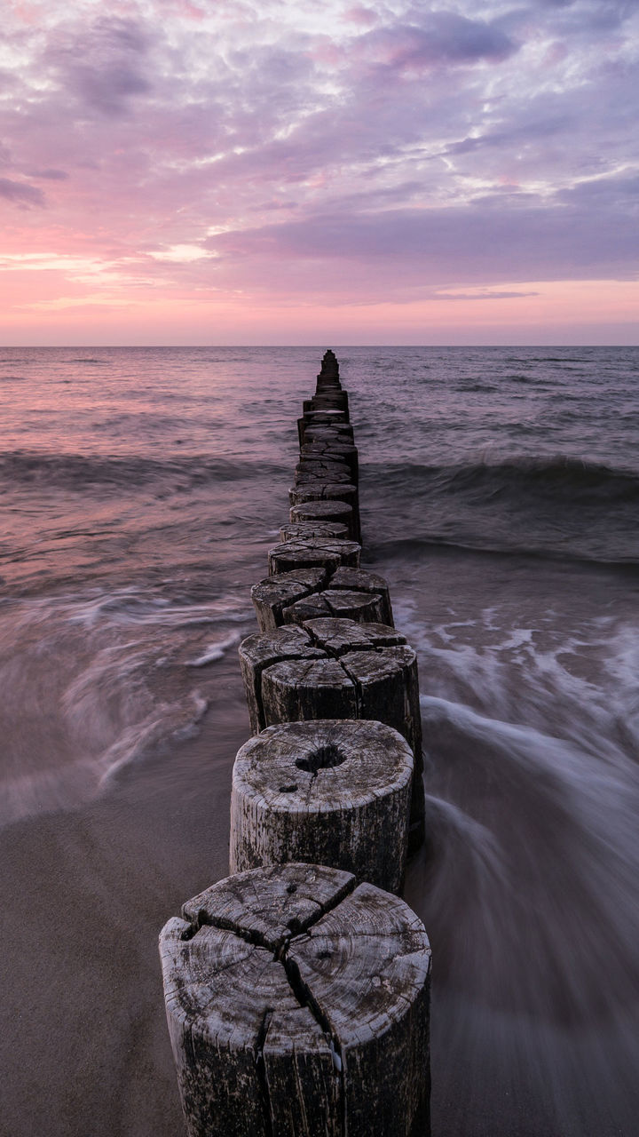 sunset, cloud - sky, sea, travel, tourism, block shape, beauty in nature, history, scenics, horizon over water, tranquility, beach, water, outdoors, tranquil scene, no people, nature, sky, day