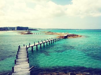 Pier on sea against sky