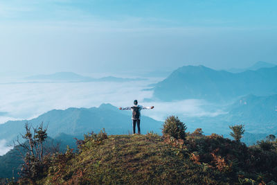 Man on mountain against sky