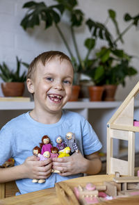 Boy playing with wooden toy at home