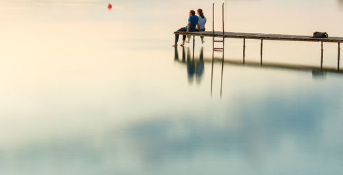 People on sea against sky