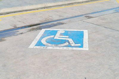 High angle view of arrow sign on road