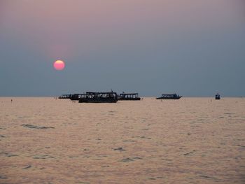 Scenic view of sea against clear sky during sunset