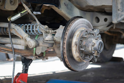 The front wheel of the car was removed to repair the brake system.