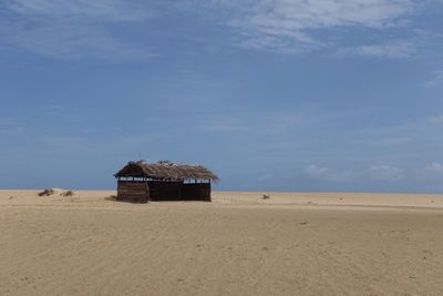 Lifeguard hut on beach against sky