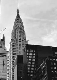 Low angle view of buildings against cloudy sky