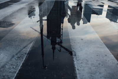 High angle view of puddle on street during rainy season