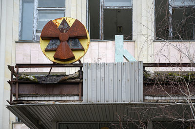 Rusty metal fence against old building