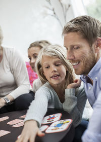 Family playing puzzle game at home