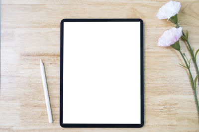 High angle view of white and laptop on table