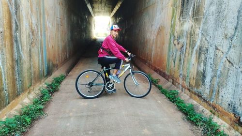 Woman riding bicycle on wall