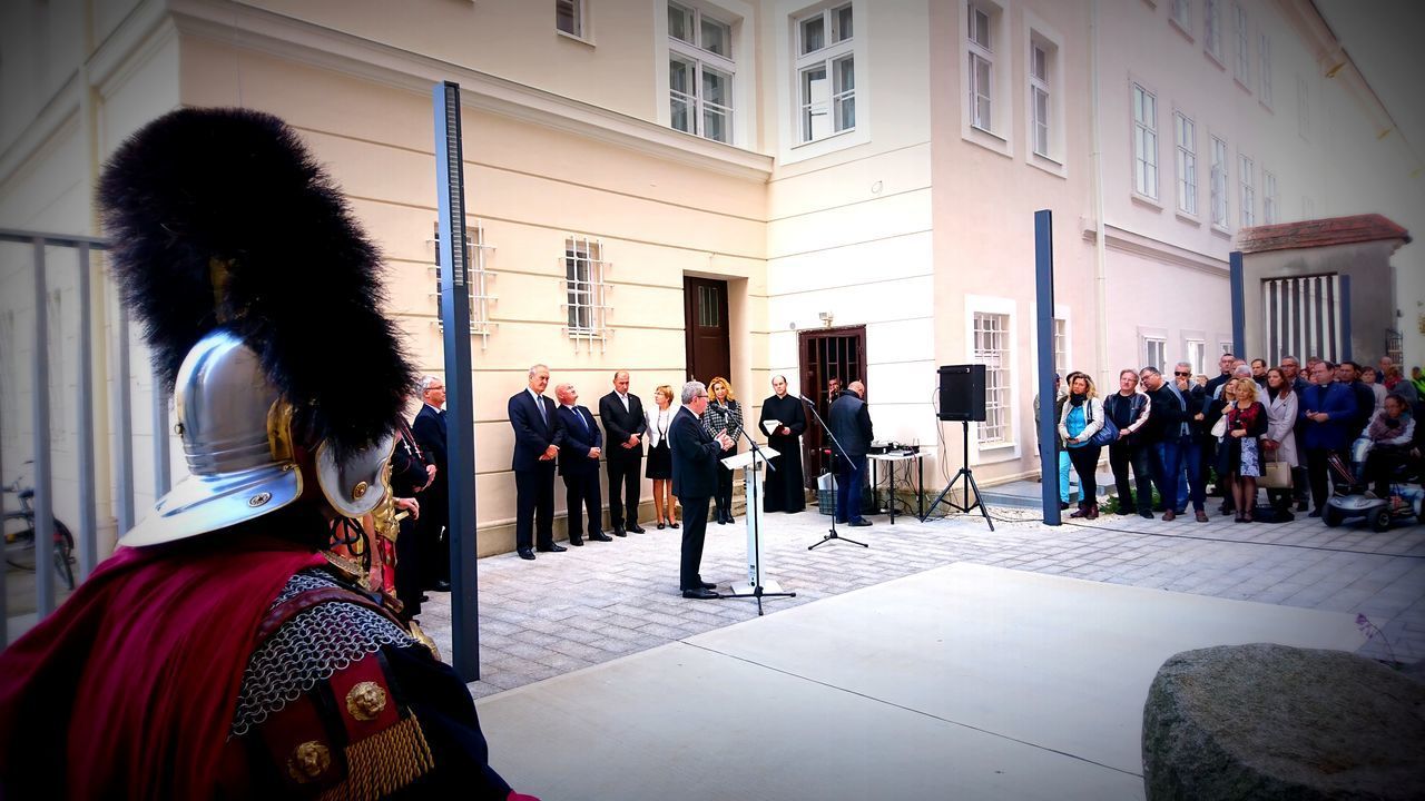 PEOPLE STANDING IN FRONT OF OFFICE BUILDING