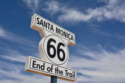 Low angle view of road sign against sky