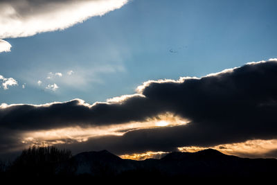 Scenic view of silhouette mountains against sky at sunset