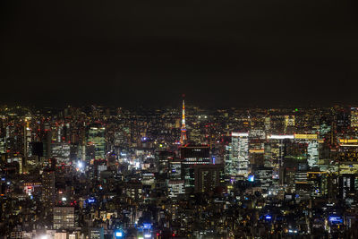 Aerial view of city lit up at night