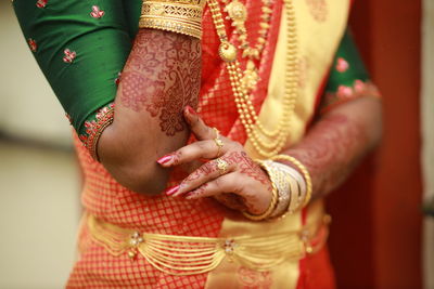 Midsection of woman wearing wedding dress