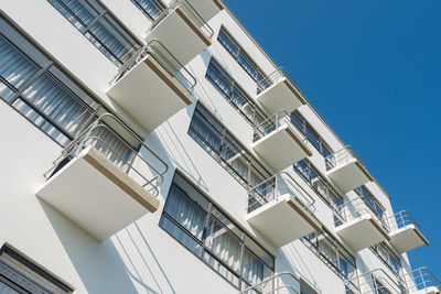 Low angle view of buildings against clear blue sky