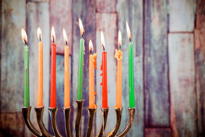 Close-up of multi colored candles on wood