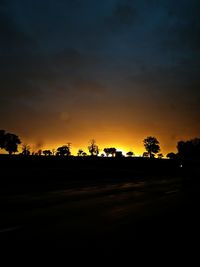 Silhouette trees against sky during sunset