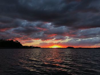 Scenic view of dramatic sky over sea during sunset