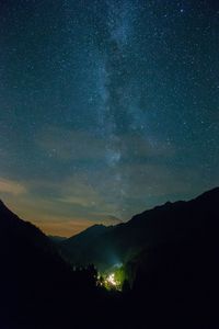 Scenic view of mountains against sky with star field