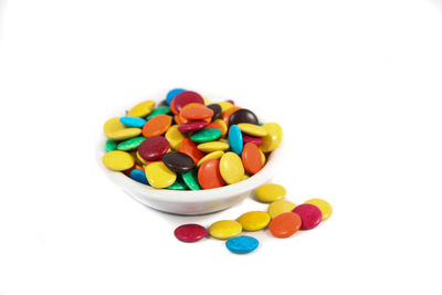 Close-up of multi colored candies against white background