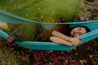 Woman lying down on hammock