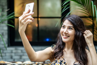 Portrait of young woman using mobile phone