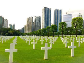 Row of cemetery against sky in city