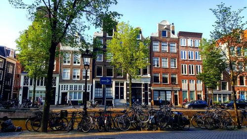 Bicycle by building against sky