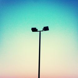 Low angle view of street light against clear blue sky