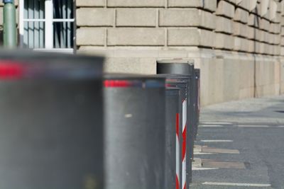 Close-up of garbage bin against wall in city