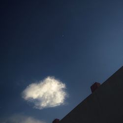 Low angle view of silhouette building against sky at night