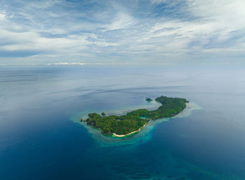 Top view of tropical island in the blue sea with sandy beach. danjugan islands, philippines.