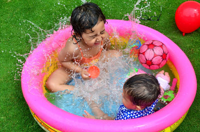 Happy children playing in swimming pool