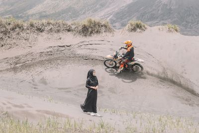 Man riding motorcycle on sand