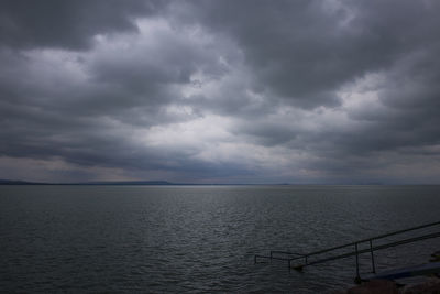 Scenic view of sea against storm clouds