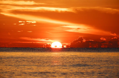 Scenic view of sea against orange sky