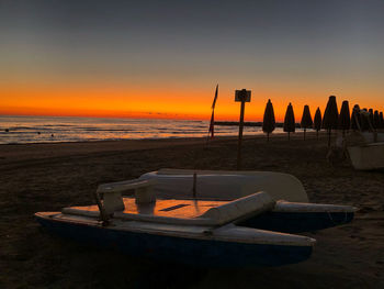 Scenic view of beach against sky during sunset