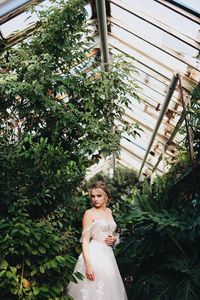 Woman standing against plants