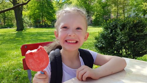 Portrait of cute girl sitting in park