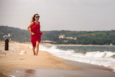 Full length of man standing on beach