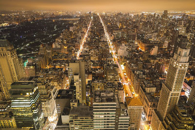 Aerial view of city lit up at night