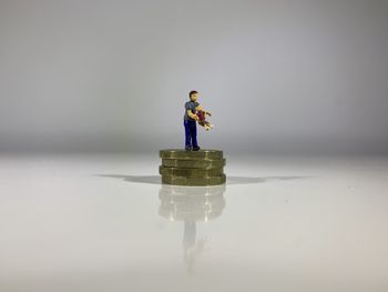 Digital composite image of toy on table against white background